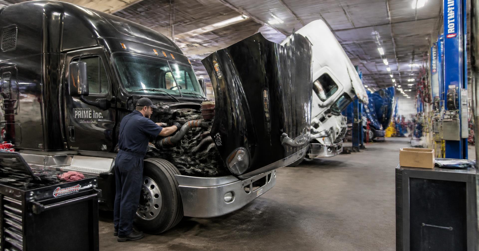 Diesel mechanic repairing a heavy-duty semi truck at K2 Truck Repair Shop